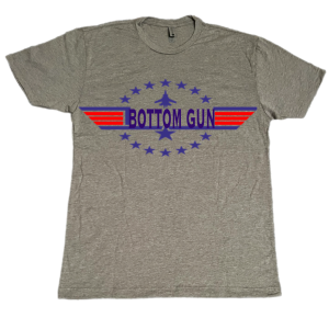 T-shirt that has the words bottom gun and the decorative stars and a jet fighter plane printed on it.
