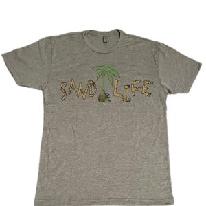 T-shirt that has the words sand life written on it and the picture of a palm tree with a ruck sack and army rifle leaning on it.